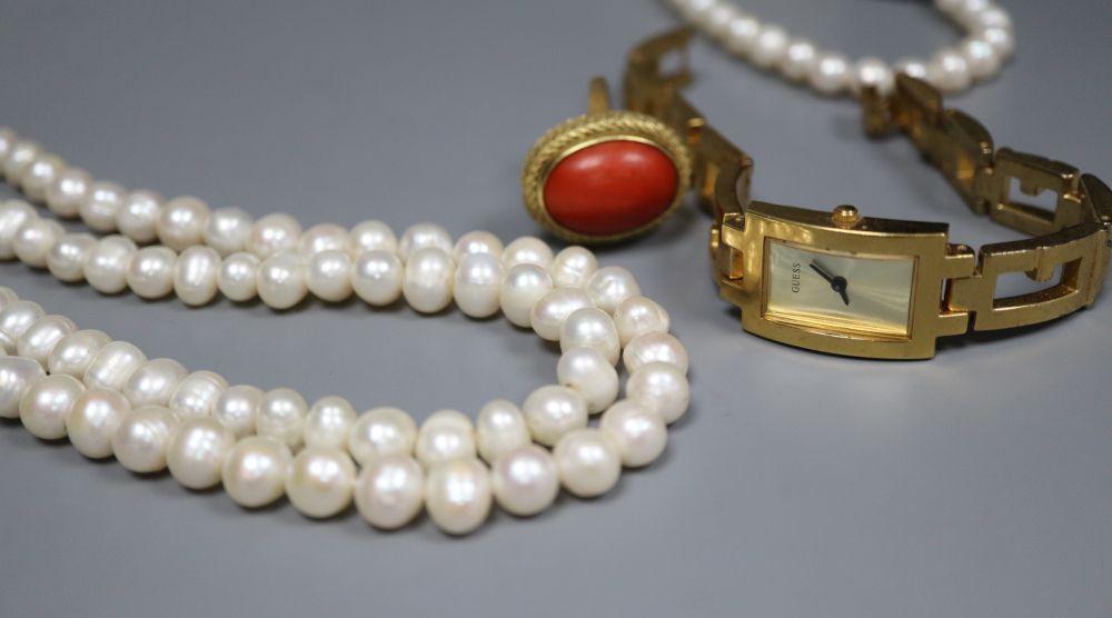 A 750 yellow metal and cabochon coral ring, size L, gross 10.4 grams, two freshwater cultured pearl necklaces and a wrist watch.